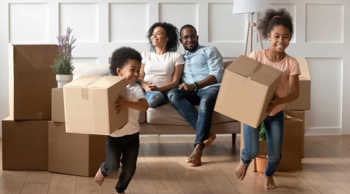 Family relax as they move into their first home