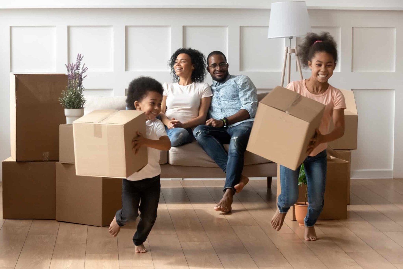 Family relax as they move into their first home