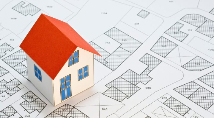 mini house with magnifying glass