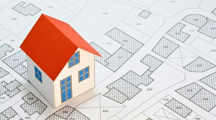 mini house with magnifying glass