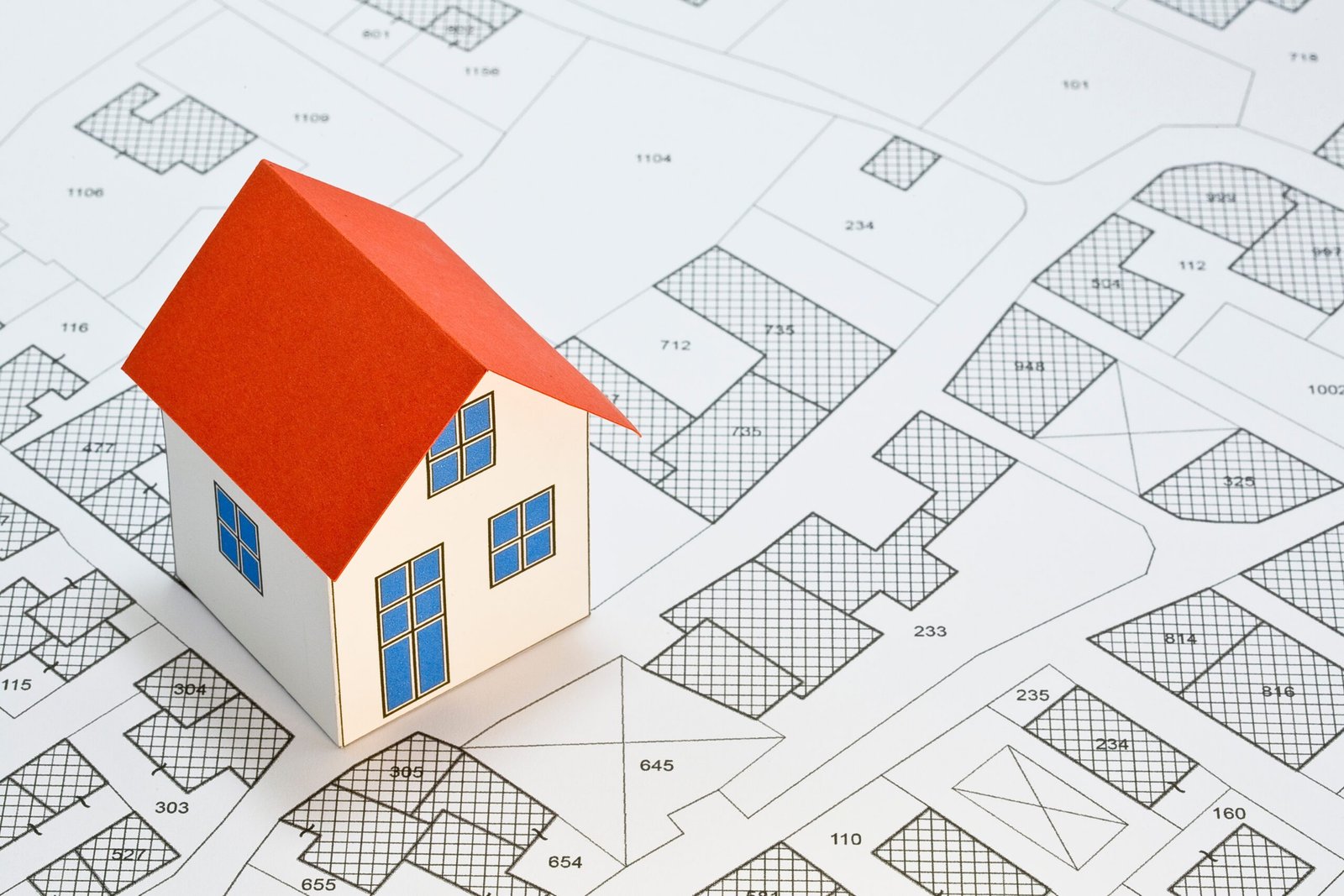 mini house with magnifying glass