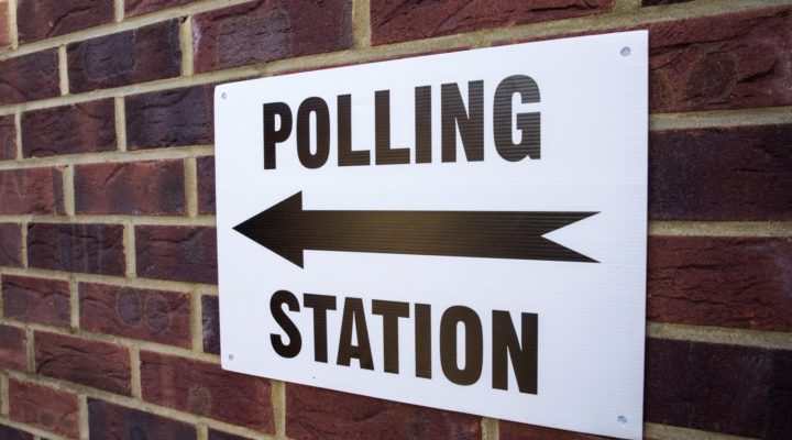 Polling Station sign on brick wall
