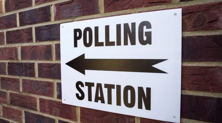 Polling Station sign on brick wall