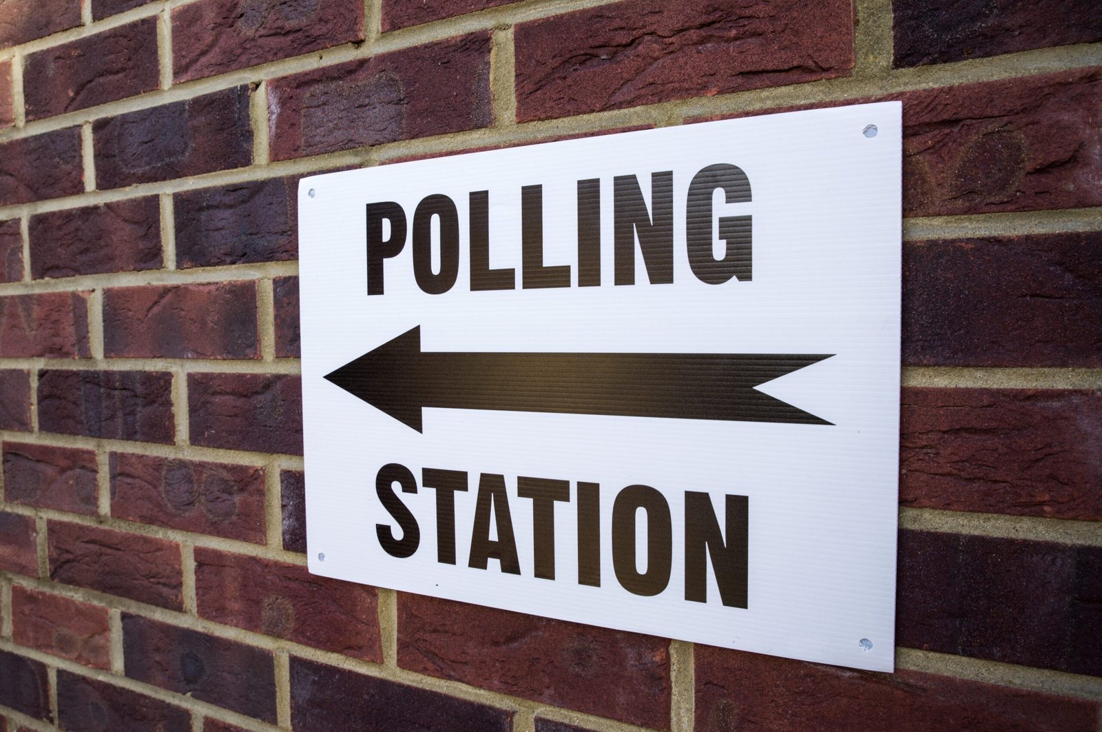 Polling Station sign on brick wall