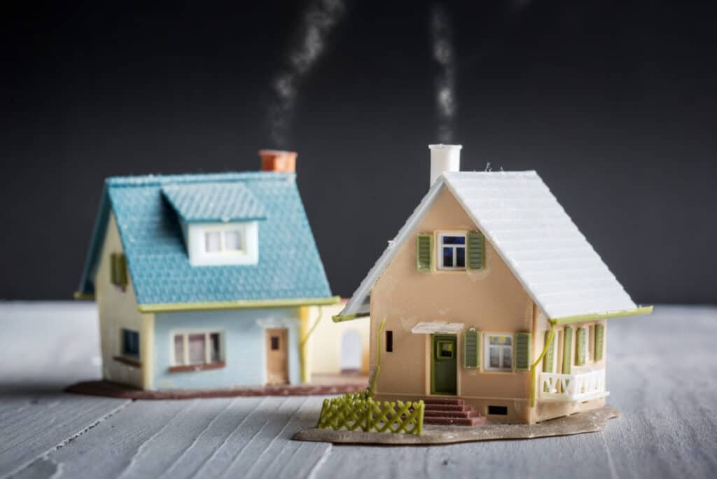 Two houses side by side in a quaint neighborhood, representing the concept of buying a second home as a contractor