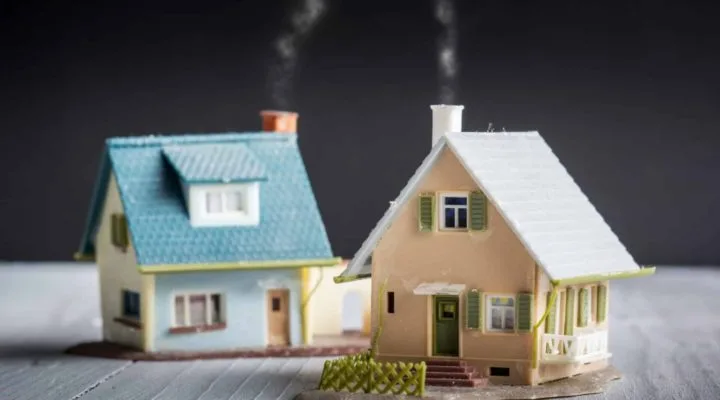 Two houses side by side in a quaint neighborhood, representing the concept of buying a second home as a contractor