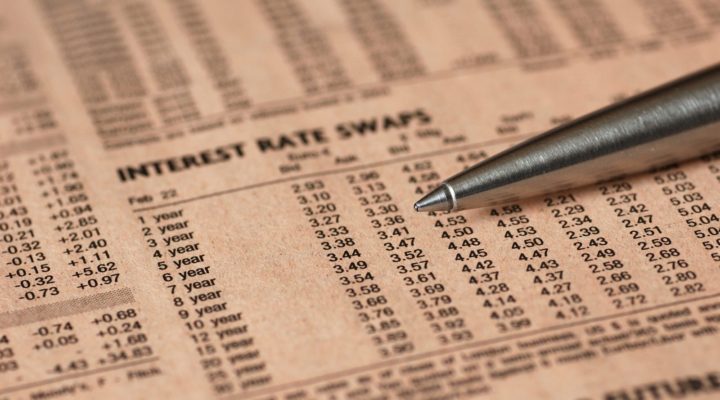 Newspaper showing a table with swap rates and a pen