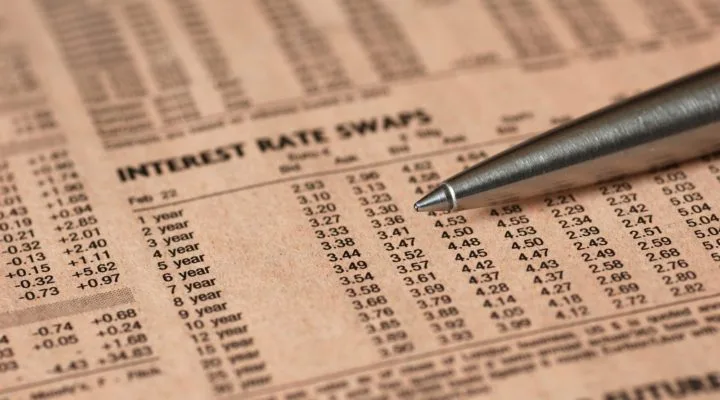 Newspaper showing a table with swap rates and a pen